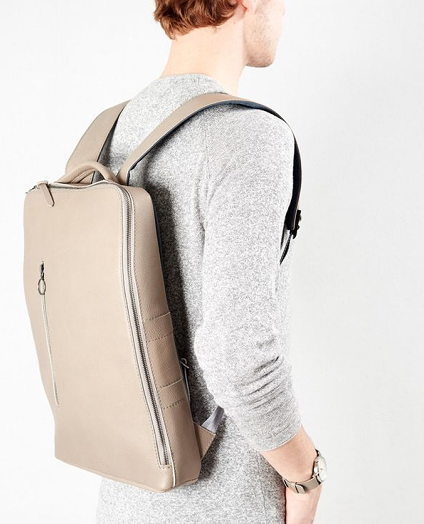 Image of a model with a beige color backpack